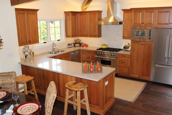 Quartz slab counters with custom tile splash.