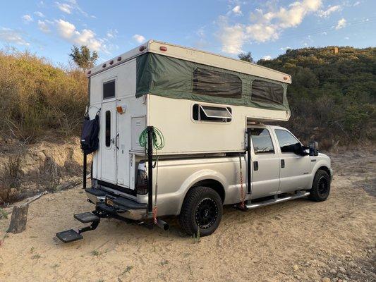 Camper with camper mounts installed by broken wheel rv