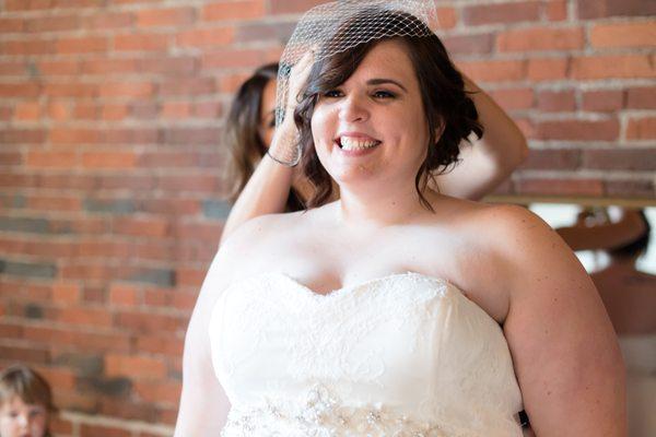 My sister-in-law applying my veil.