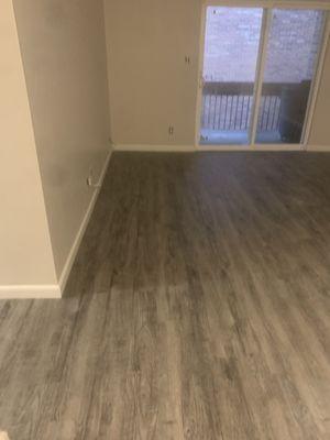 Vinyl plank flooring installed with baseboard