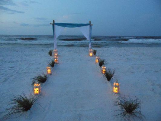 3 pole bamboo arch with lanterns and grass walkway