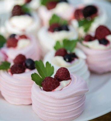 Bite size mini pavlovas with cream and berries