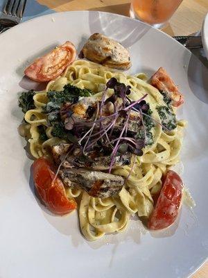 Pasta special - chicken fettuccine with tomatoes and kale