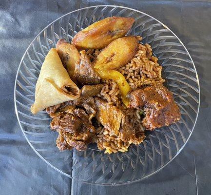 Buffet plate with Jollof Rice and Fried Plantains also beef fish and a samosa