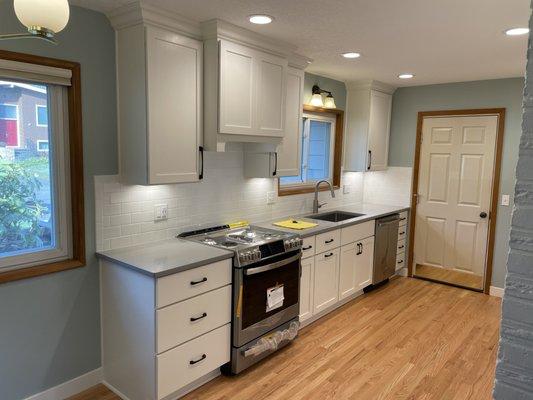 Painted white kitchen cabinets with gray countertop