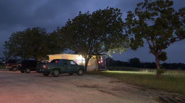 Evening photo of restaurant about 100 feet off roadway.