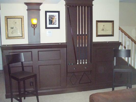 Built in pool cue rack and wainscoting. This goes all the around the pool table area