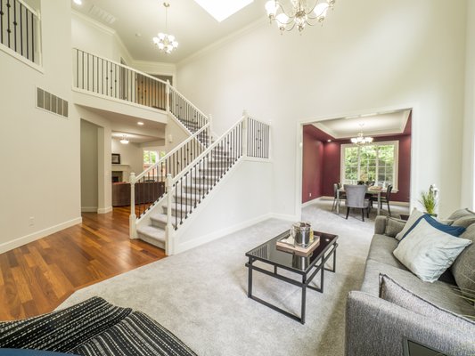 Volume ceilings, railing and bannister, loads of windows all over newly refinished floors (not a drop of paint or a scratch).