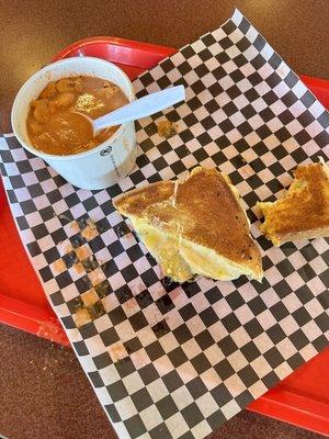 Regular grilled cheese sandwich and a bowl of tomato soup