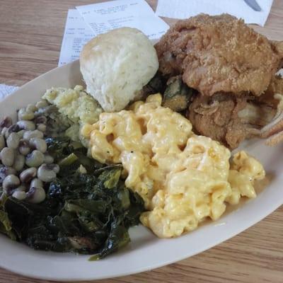 This plate is mean! Black Eyed peas, collards, stuffing,  mac n cheese, biscuits, fried chicken, fried fish, okra, cracklins.