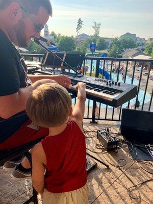 Trying out the piano at one of our gigs!