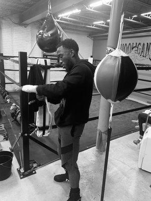 Boxer Tracy TOO FAST Williams wrapping his hands before practice.