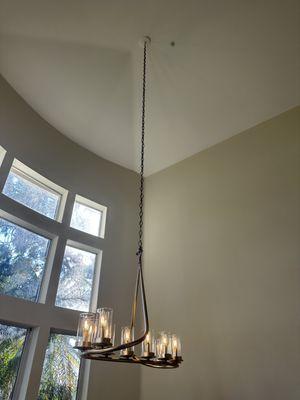 Installation and power up of a chandelier on a very tall ceiling.