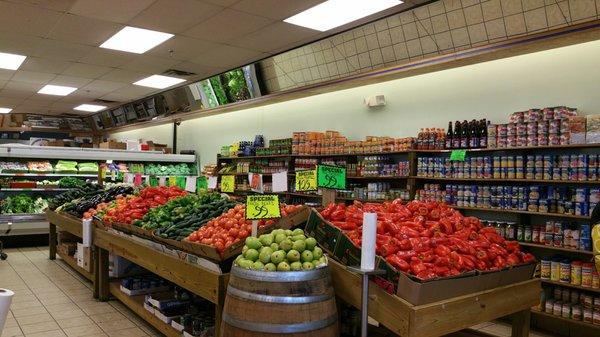 Fruits/veggies in forefront and packaged items along one of the walls.