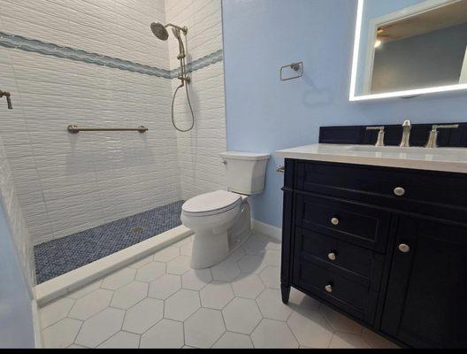 Vanity, mirror, shower, flooring