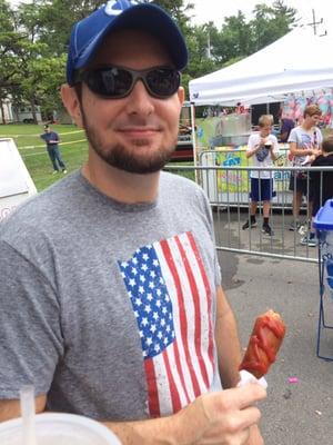 Husband enjoying a corn dog.