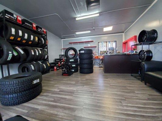 Indoor area with a few tires and 2 couches to sit on.