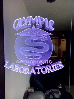 An Orthodontic Laboratory, Olympic Laboratories Logo in purple