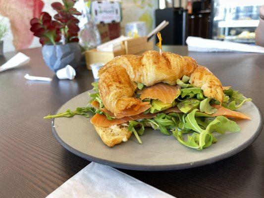 Avocado and salmon on a croissant.