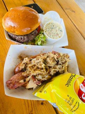 burger with potato salad and signature brat with chips