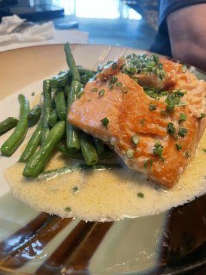 Salmon over risotto and green beans.