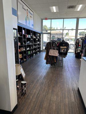 The shelf of glassware and rows of clothing. There is only one more row of clothes not shown on the picture.