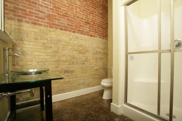 Urban bathrooms with contemporary glass lavatories