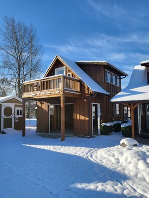 16x24 2 story garage cedar siding all around with balcony on second floor, and covered deck behind