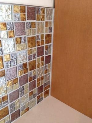 Glass mosaic backsplash. Schlueter trim