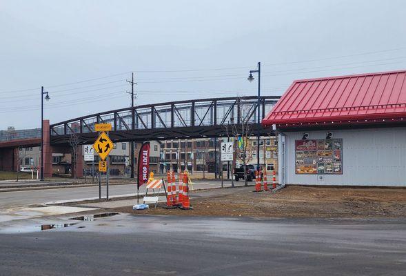 Located next to the trail bridge and roundabout downtown