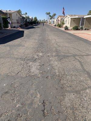 Streets are cracked asphalt, dirt, and rocks.