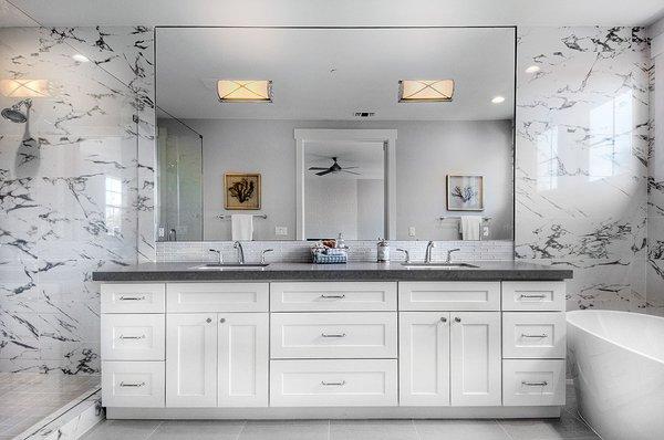 White cabinetry, Deep grey counter top & porcelain wall tile