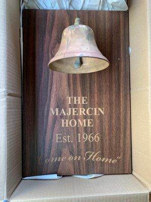 Old brass bell mounted to a walnut engraved plaque