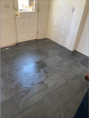 Wood floor was damaged, so Greg installed a gorgeous slate floor in the kitchen.