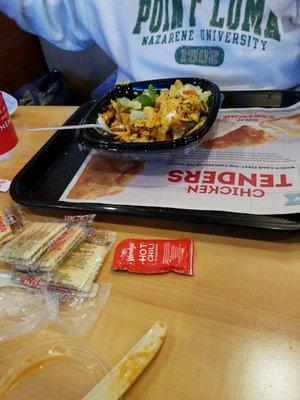 The so called taco salad. It is a salad with salsa, tortilla chips and wendys chilli.