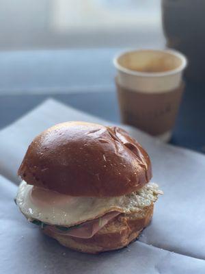 Breakfast sandwich and cappuccino.