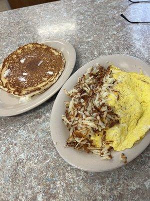 Ham and cheese omelette with hash browns and a pancake