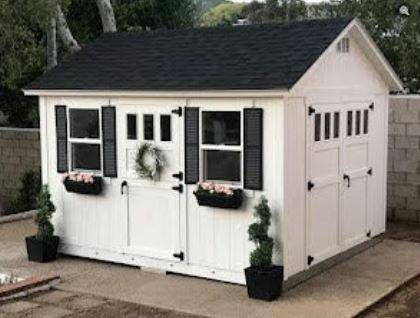 Premier Ranch with upgraded shutters, window boxes, black hardware and transoms windows in door.