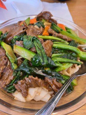 Beef and Chinese broccoli chow fun with sauce.