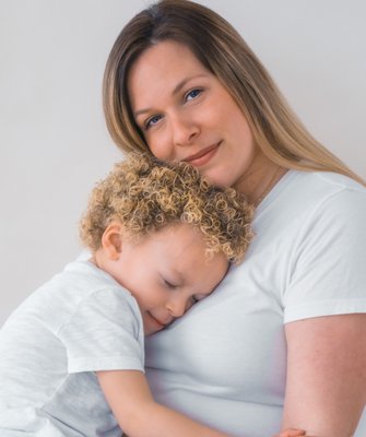 Mother and son pose for studio portrait in Queens, NY.