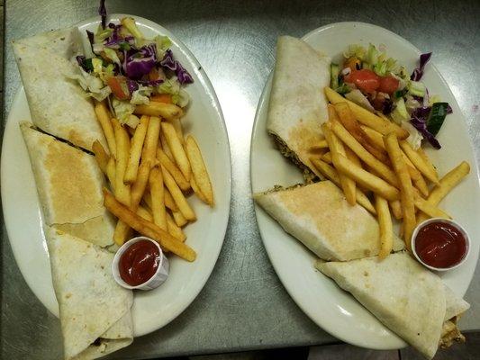 Chicken and beef Shawarma Sandwich with fries.