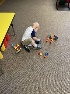 My little guy building with stacking cups