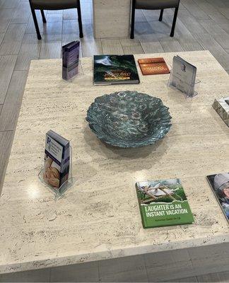 COFFEE TABLE, at center of LOBBY.