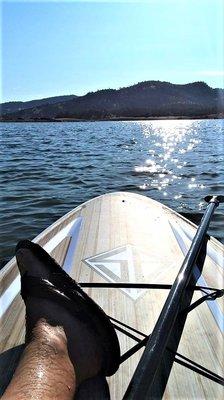 Paddleboarding at Lake Hogan in Valley Springs. Stand Up Paddleboard rental from $25 for 2 hours available at Oak Savanna Clothing & Supply.