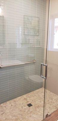 Removed tub/shower and created zero curb shower with grab bar