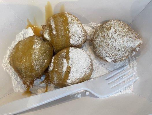 Deep Fried Oreo cookies with powered sugar and sea salt caramel drizzled on top