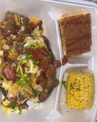 Loaded Brisket baked potato with parsley flakes, cheese, chives and bacon, honey glazed cornbread and corn on the cob .