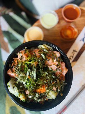 Double salmon poke w white rice, carrots, cucumber, pineapple, seaweed salad, and ginger. Wasabi, coconut-ginger, and hot korean sauce.