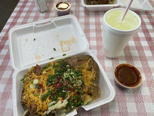 Texas size baked potato with all the fixings and brisket. BBQ sauce on the side, and a lite lemonade. YUM!!