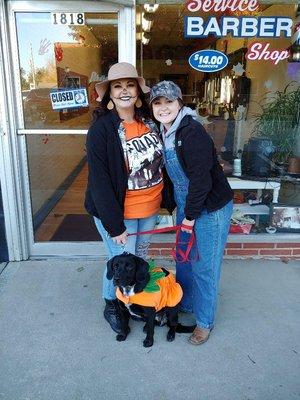 Handing out candy Halloween at Service Barber Shop for downtown trick or treaters.